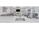 Modern white kitchen with breakfast bar and open living area at 600 Market St # 210, Celebration, FL 34747