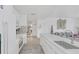 Modern white kitchen with stainless steel appliances and breakfast bar at 600 Market St # 210, Celebration, FL 34747