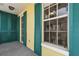 Covered balcony with teal shutters and access to the interior at 600 Market St # 340, Celebration, FL 34747