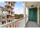 Balcony with white railings and views of a courtyard and tower at 600 Market St # 340, Celebration, FL 34747