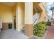 Building entrance featuring an elevator and stairs, surrounded by lush landscaping at 600 Market St # 340, Celebration, FL 34747