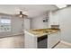 Kitchen and living space with wood floors, ceiling fan, and tv at 600 Market St # 340, Celebration, FL 34747