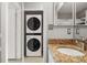Convenient laundry area with stacked washer and dryer near bathroom vanity at 600 Market St # 340, Celebration, FL 34747