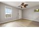 Living room with wood floors, ceiling fan, and window at 600 Market St # 340, Celebration, FL 34747