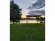 Backyard features a gazebo, lush green lawn, and tranquil water view for outdoor enjoyment at 6002 Renaissance Ct, St Cloud, FL 34772