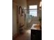 Bathroom with a glass-enclosed shower and neutral decor at 6002 Renaissance Ct, St Cloud, FL 34772