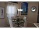 Charming dining area with a glass-top table, seating for five, and elegant lighthouse-themed wall art at 6002 Renaissance Ct, St Cloud, FL 34772
