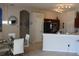 Dining area with a glass table, modern lighting, and seamless access to the kitchen at 6002 Renaissance Ct, St Cloud, FL 34772