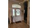 Inviting front door with decorative glass, transom window, and tiled entryway, creating a warm welcome at 6002 Renaissance Ct, St Cloud, FL 34772