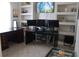 Functional home office with modern desks, built-in shelves, and neutral color palette at 6002 Renaissance Ct, St Cloud, FL 34772
