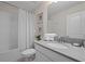 Clean bathroom with shower/tub combo, gray vanity, and patterned shower curtain at 641 Pebble Beach Dr, Davenport, FL 33896