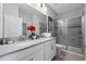 Bathroom with double vanity, a large shower, and grey tile floors at 641 Pebble Beach Dr, Davenport, FL 33896