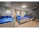 ' bedroom with three twin beds, Star Wars mural, and wood floors at 641 Pebble Beach Dr, Davenport, FL 33896