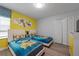 ' bedroom with two twin beds, Minions theme, and yellow walls at 641 Pebble Beach Dr, Davenport, FL 33896