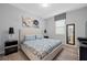Bedroom with queen bed, floral artwork, and wood-look floors at 641 Pebble Beach Dr, Davenport, FL 33896