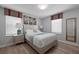 Bedroom with queen bed, light-colored bedding, and wood floors at 641 Pebble Beach Dr, Davenport, FL 33896
