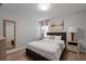 Bright bedroom with a queen bed and wood floors at 641 Pebble Beach Dr, Davenport, FL 33896
