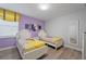 Bedroom with two twin beds, Belle themed bedding, and purple walls at 641 Pebble Beach Dr, Davenport, FL 33896