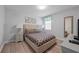 Bedroom with queen bed, geometric bedding, and wood-look floors at 641 Pebble Beach Dr, Davenport, FL 33896