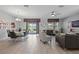 Elegant dining room with modern table and chairs, adjacent to living area at 641 Pebble Beach Dr, Davenport, FL 33896