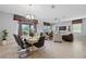 Open concept dining room with modern chandelier and view of living area at 641 Pebble Beach Dr, Davenport, FL 33896