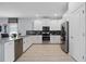 Modern kitchen with white cabinets, stainless steel appliances, and gray countertops at 641 Pebble Beach Dr, Davenport, FL 33896