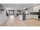 Open concept kitchen with island, stainless steel appliances, and view of living area at 641 Pebble Beach Dr, Davenport, FL 33896