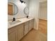 Double vanity bathroom with quartz countertops and large mirrors at 656 Oakford Way, Orlando, FL 32811