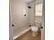 Updated bathroom with a white tiled shower and flooring at 656 Oakford Way, Orlando, FL 32811