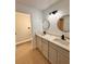 Double vanity bathroom with quartz countertops and large mirrors at 656 Oakford Way, Orlando, FL 32811