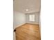 Bright bedroom with light wood flooring and a large window at 656 Oakford Way, Orlando, FL 32811