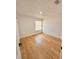 Bright bedroom with light wood flooring and a large window at 656 Oakford Way, Orlando, FL 32811