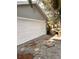 White garage door and driveway with fallen leaves at 656 Oakford Way, Orlando, FL 32811