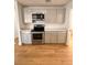 Modern kitchen with stainless steel appliances and light gray cabinets at 656 Oakford Way, Orlando, FL 32811