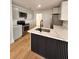 Modern kitchen with island, stainless steel appliances, and light gray cabinets at 656 Oakford Way, Orlando, FL 32811