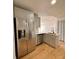 Modern kitchen with stainless steel appliances and light gray cabinets at 656 Oakford Way, Orlando, FL 32811