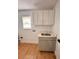 Updated laundry room with white cabinets and a quartz countertop at 656 Oakford Way, Orlando, FL 32811