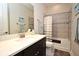 Clean bathroom with shower/tub combo and dark vanity at 7637 Sand Pierre Ct, Kissimmee, FL 34747