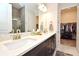 Double vanity bathroom with walk-in closet access at 7637 Sand Pierre Ct, Kissimmee, FL 34747