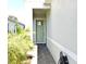 Front entrance with a light green door and a brick walkway at 7637 Sand Pierre Ct, Kissimmee, FL 34747
