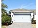 House exterior featuring a two-car garage and a paved driveway at 7637 Sand Pierre Ct, Kissimmee, FL 34747