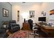 Bright home office features built-in wooden desk and comfortable seating at 7637 Sand Pierre Ct, Kissimmee, FL 34747