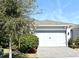 Single-story home with white garage door and landscaped front yard at 7637 Sand Pierre Ct, Kissimmee, FL 34747