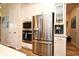 Modern kitchen with stainless steel appliances and white cabinetry at 7637 Sand Pierre Ct, Kissimmee, FL 34747