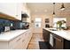 Eat-in kitchen with island, stainless steel appliances, and white cabinets at 7637 Sand Pierre Ct, Kissimmee, FL 34747