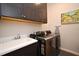 Laundry room with modern washer and dryer, and plenty of cabinet space at 7637 Sand Pierre Ct, Kissimmee, FL 34747