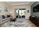 Bright living room with comfy seating, large sliding glass doors and a view to the patio at 7637 Sand Pierre Ct, Kissimmee, FL 34747