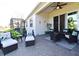 Covered patio with wicker furniture and a view of the backyard at 7637 Sand Pierre Ct, Kissimmee, FL 34747