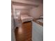 Bedroom features a bed, white furniture, and wood-look tile flooring at 768 E Michigan St # 75, Orlando, FL 32806