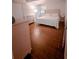 Bright bedroom with white furniture, headboard, and wood-look tile flooring at 768 E Michigan St # 75, Orlando, FL 32806